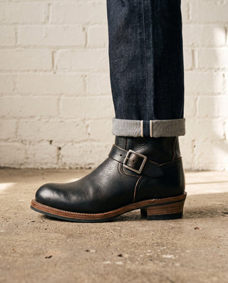Black 3530 engineer boots worn with cuffed selvedge denim, side profile