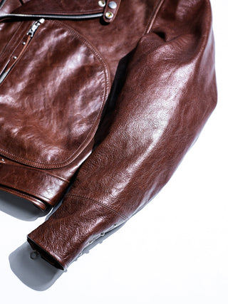 Four round studs on the sleeve of the brown Archetype jacket, a Leather Togs signature