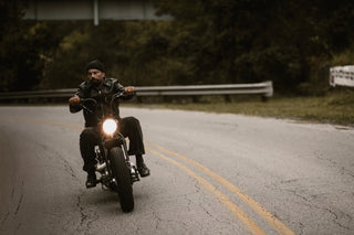 Rider riding the centerline of an empty two-lane road