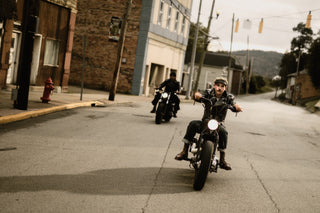 Two riders coming down a small town main street